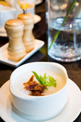 plain congee with crispy bacon and sliced onion leaks