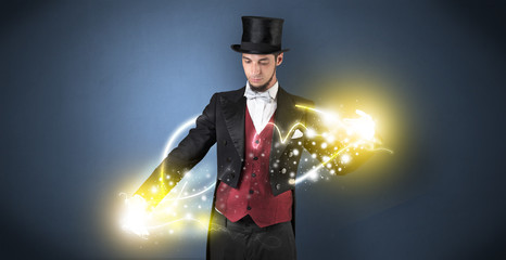 Magician holding his sparkling power between his two hand