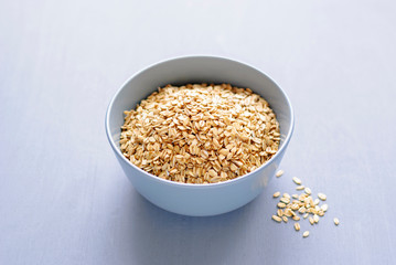 Gray bowl of dry oatmeal