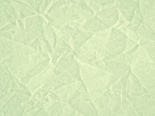 Texture of light green crumpled craft paper. Texture for design, abstract background