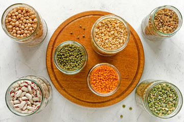 Assorted dry legumes and pulses in glass jars