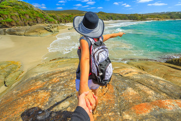 Follow me POV. Woman in hat holding hand of her friend at Waterfall Beach in Denmark, Western Australia. Backpacker at William Bay NP a popular Australian travel destination.