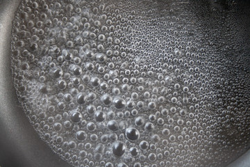 Water bubbles boiling in a pan
