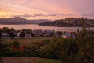 Sunset over village of Akaroa, Canterbury, New Zealand