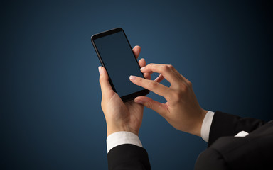 Mockup for female hand using frameless smartphone with dark background
