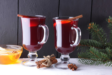 Mulled wine and Christmas tree branches on black and white background. Christmas mulled wine,...