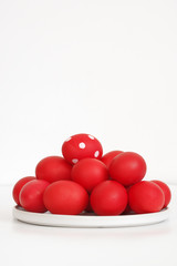 Red Easter eggs in plate