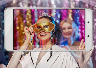Photo of young excited woman dancing on xmas party, smart device concept