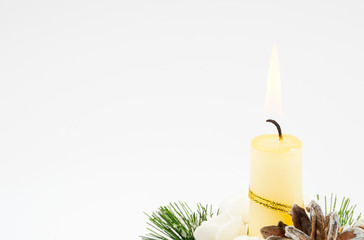 Obraz na płótnie Canvas Christmas composition on a white background. Burning candle, fir branch, cones. Merry Christmas and happy New year with copy space.