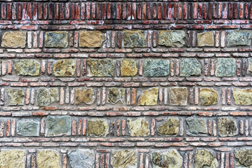 Detail of a stone wall with different size of rocks.