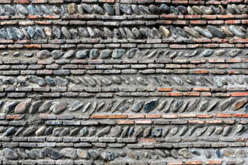 Detail of a stone wall with different size of rocks.