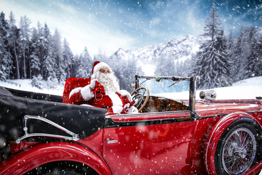 Santa Claus In Red Car And Winter Snow 