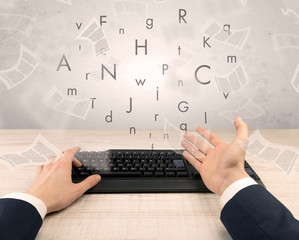 First person view of an elegant businessman hand  typing with fluttering papers around
