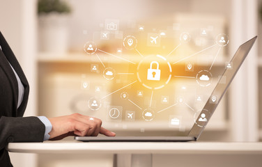 Business woman below chest working on laptop in a cozy homey environment with secured connection concept
