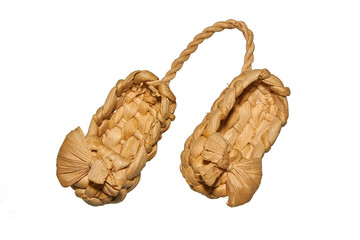 Old Russian sandals made from bast on a white background