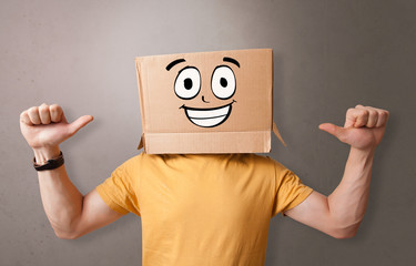 Young boy standing and gesturing with a cardboard box on his head
