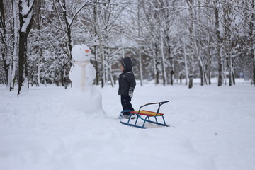 Fototapeta na wymiar child park winter play snow fun emotions