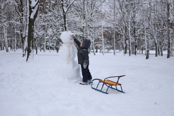 Fototapeta na wymiar child park winter play snow fun emotions