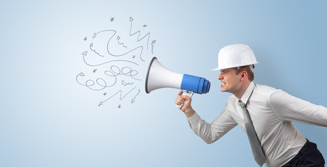 Fototapeta premium Young architect constructor yelling with megaphone and copyspace 