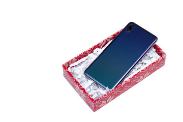 New beautiful flagship smartphone with two cameras in a red gift box on a white background