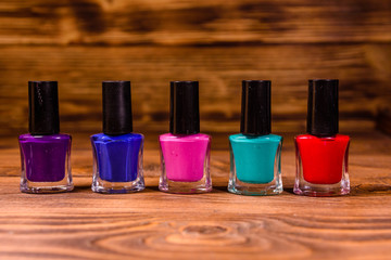 Different nail polishes on a wooden table