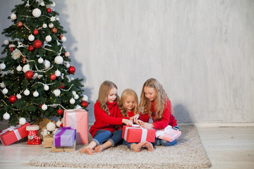 Christmas holiday three girl with gifts the new year tree decoration on a grey background gifts