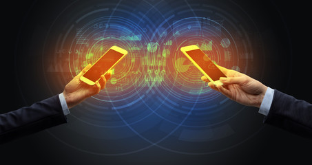 Close up of two smartphones syncing business data