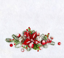 Christmas decoration. Flower of red poinsettia, twigs christmas tree, christmas red balls, cones pine and red berries covered snow on snow with space for text. Top view, flat lay