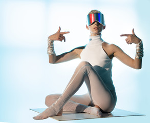 A man in virtual glasses shows a sign of attention to himself