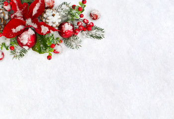 Fototapeta na wymiar Christmas decoration. Flower of red poinsettia, twigs christmas tree, christmas red balls, cones pine and red berries covered snow on snow with space for text. Top view, flat lay