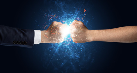 Fototapeta na wymiar Two hands fighting with light, glow, spark and smoke concept 