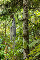 halloween decoration hanging from a tree made from gray cloth