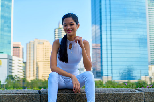 Beautiful woman posing - sitting and lovely smiling face