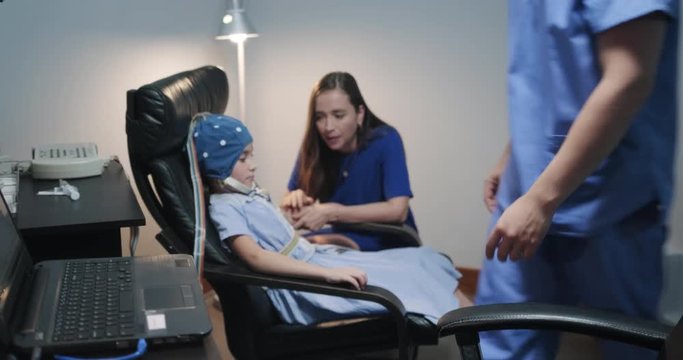 Little Girl and Mother Attending Pediatric Clinic for Neurological Evaluation