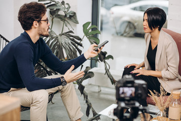 awesome man and attractive fashion girl is having an interview. close up photo. businesswoman...