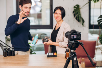 family presenting a new cosmetics. camera is recording film about body care. closeup photo