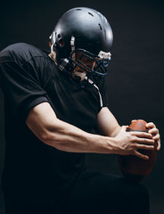 American football player with helmet and armour in the decisive game takes responsibility of the results of the game .