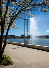 View of the Captain Cook Memorial Water Jet from near the National Library, Canberra. This image taken in early spring 2018 with the Manchurian Pear in flower.
