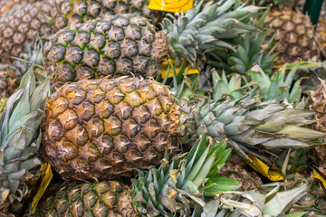 Ripe juicy pineapple background. Pineapple pile on the market