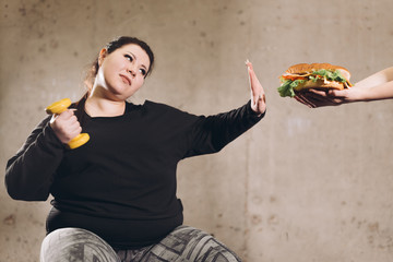stop eating fast food, go in for sport.plump girl refuces jink food. healthy life, health and body...