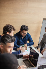 Close up of multiracial colleagues chat talking or discussing something in office, black man speak...
