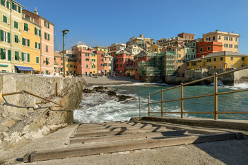 View from the dock of the old fishing village of Boccadasse, a district of Genoa, with the typical colored houses and the little beach, Genoa, Liguria, Italy