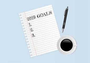 2019 GOALS on note paper with coffee cup and pen on blue background