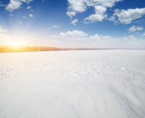 Fototapeta na wymiar Snowcovered fields on sky and sun.