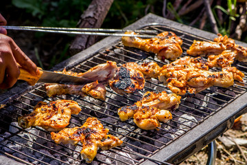 Preapring the chicken meat on the grill