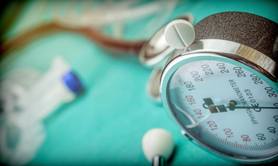White pad next to a manometer to measure blood pressure and a stethoscope in a hospital, conceptual...