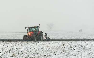 Obraz premium Tractor plowing a field