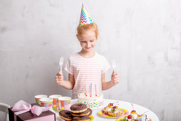 happy awesome girl holding forks and looking at the cake. close up photo. food, delicious dessert