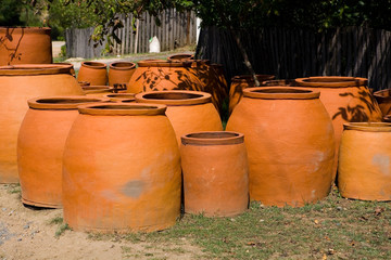 Fototapeta premium Many large earthenware jugs for wine are sold near the road.