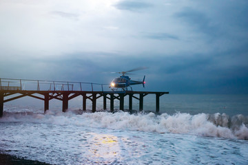 Helicopter landing during a sea storm
